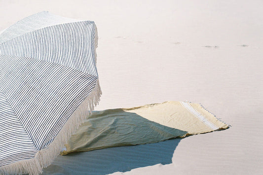 Natural Instinct beach umbrella and towel set up on the sand