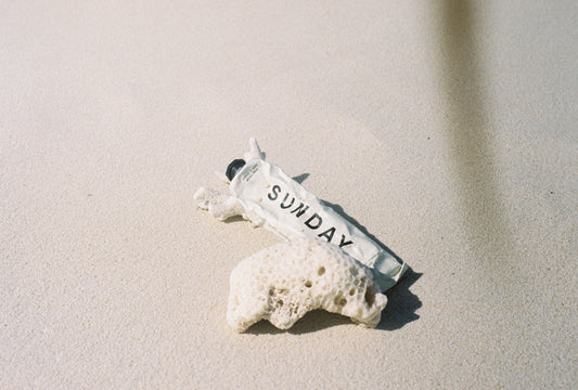 Sunday Supply Co. gel ice pack on beach sand beside coral