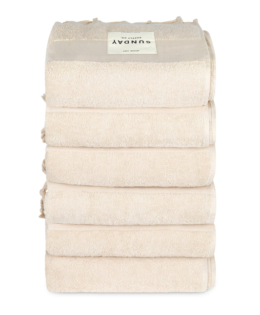 A large striped beach towel arranged on the sand for a relaxed coastal day.