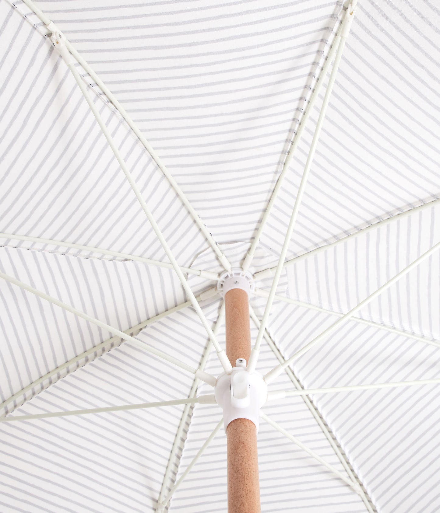 Sunday Supply Co Natural Instinct beach umbrella open and seen from underneath.